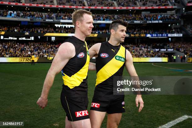 Jack Riewoldt of the Tigers and Trent Cotchin of the Tigers walk off the ground after playing their final games during the round 23 AFL match between...