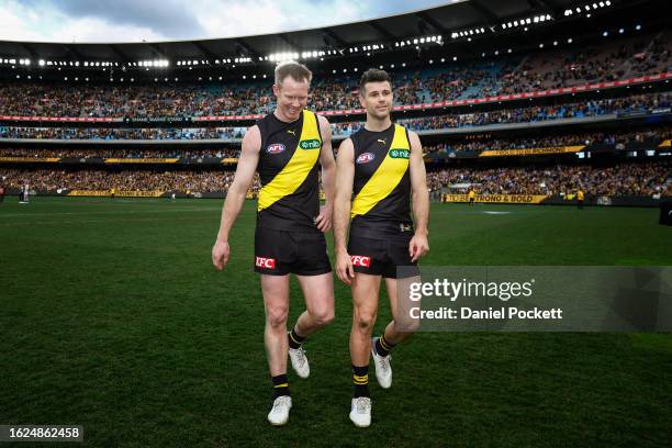 Jack Riewoldt of the Tigers and Trent Cotchin of the Tigers walk off the ground after playing their final games during the round 23 AFL match between...