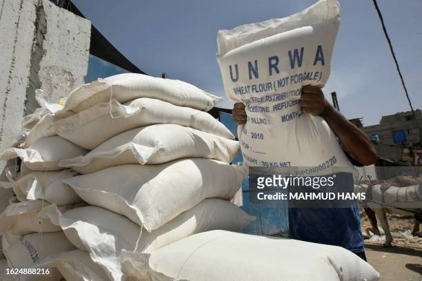 Palestinian boy carries food aid provided by the UNRWA at a warehouse in Gaza City on June 6 one day after Israel stopped another aid boat from...