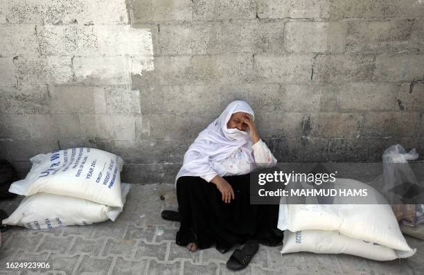 Palestinian woman waits to receive food aid at a UNRWA warehouse in Gaza City on June 6 one day after Israel stopped another aid boat from reaching...