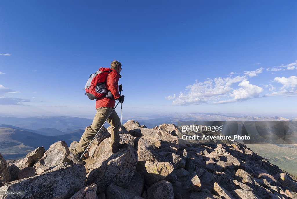 Hiker Hiking High on Mountain Summit