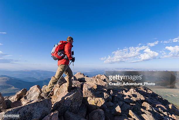 hiker hiking high on mountain summit - colorado hiking stock pictures, royalty-free photos & images