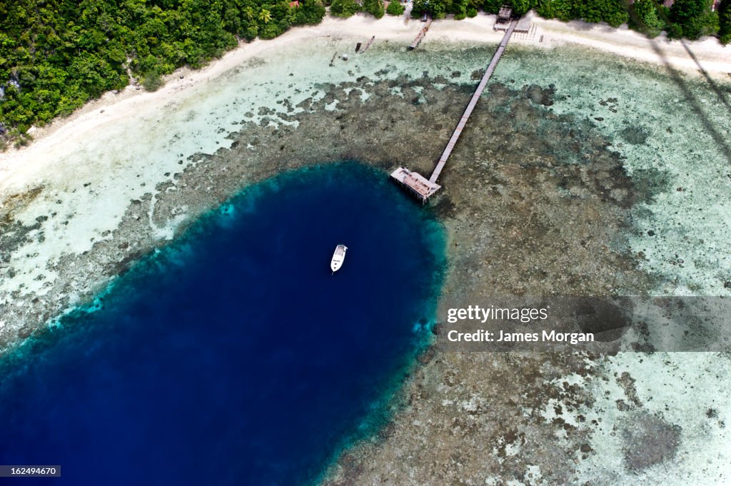 Aerial view of jetty with small boat