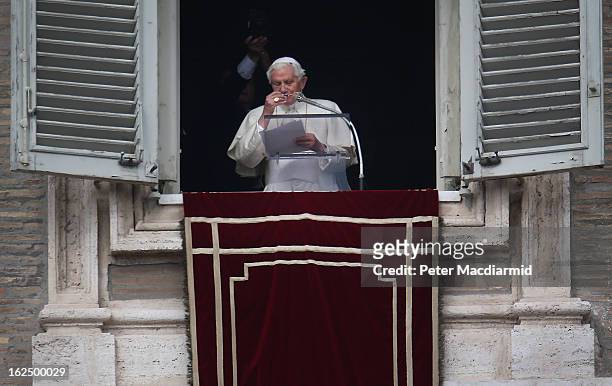 Pope Benedict XVI takes off his glasses as he finishes his last Angelus Blessing from the window of his private apartment to thousands of pilgrims...