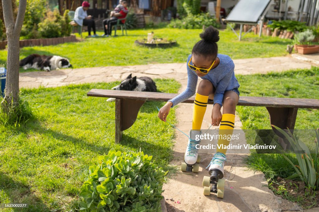 A teenage girl preparing for skating with friends