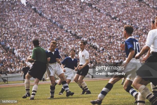 Australian goalkeeper Ken Grieves , of Bolton Wanderers, comes up against Roy Bentley of Chelsea during a match at Stamford Bridge, London, 10th...