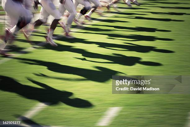 blur of american football players. - rush american football stockfoto's en -beelden