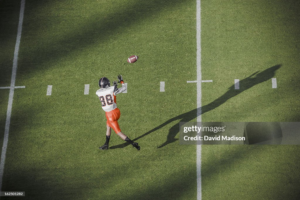 American football player catching a pass.