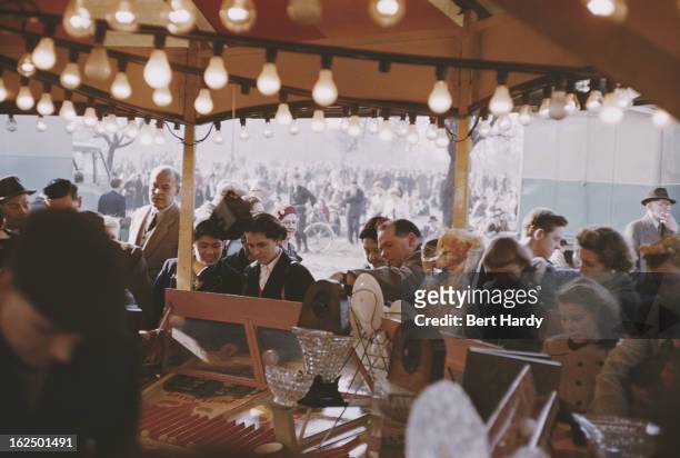 Londoners at an Easter Fair, held on Hampstead Heath, London, 1956. Original publication: Picture Post - Easter Fair - unpub