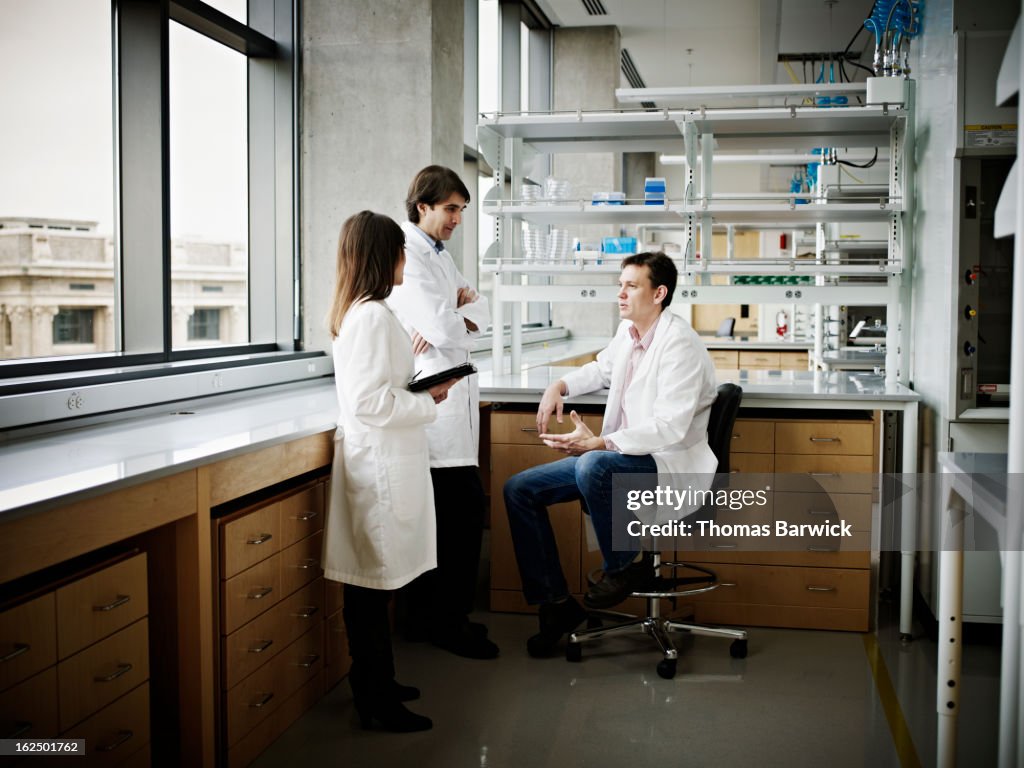 Scientists in research lab discussing project