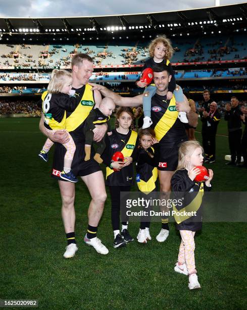 Jack Riewoldt of the Tigers and Trent Cotchin of the Tigers walk off the ground after playing their final games during the round 23 AFL match between...