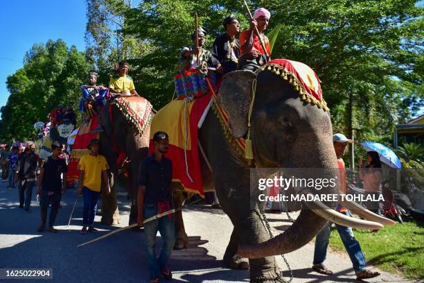 Participants ride on elephants during a parade welcoming the Islamic New Year and celebrating the culture and traditions of Thailand's southern...