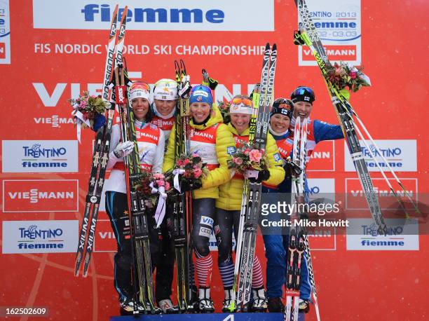 Jessica Diggins and Kikkan Randall of the United States celebrate victory on the podium with second placed Ida Ingemarsdotter and Charlotte Kalla of...
