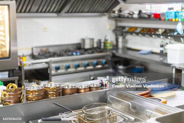 a kitchen counter in a commercial kitchen - exhaust fan stock pictures, royalty-free photos & images