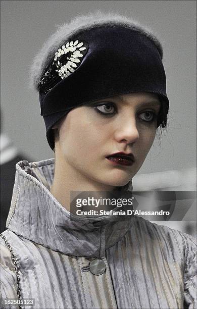 Models prepare backstage at the Emporio Armani fashion show as part of Milan Fashion Week Womenswear Fall/Winter 2013/14 on February 24, 2014 in...