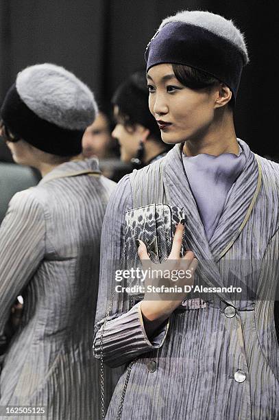 Models prepare backstage at the Emporio Armani fashion show as part of Milan Fashion Week Womenswear Fall/Winter 2013/14 on February 24, 2014 in...