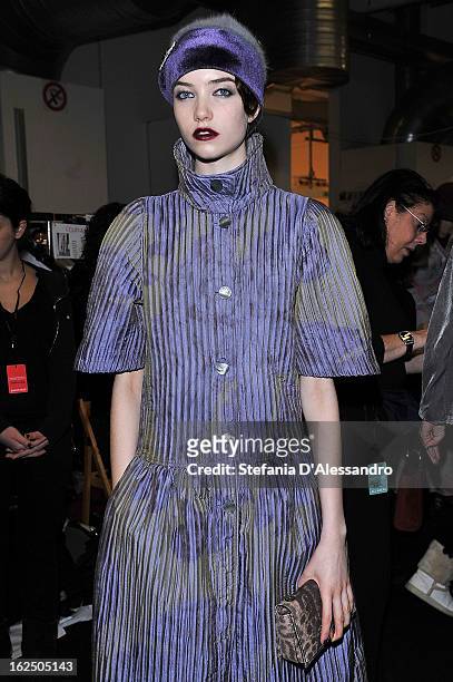 Models prepares backstage at the Emporio Armani fashion show as part of Milan Fashion Week Womenswear Fall/Winter 2013/14 on February 24, 2014 in...