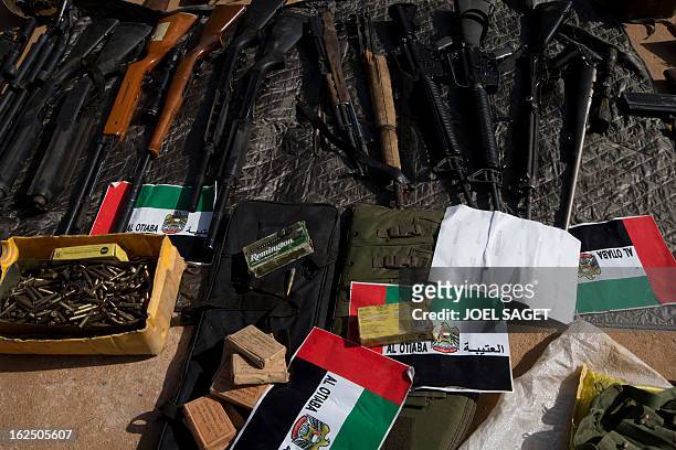 Picture of weapons and ammunitions seized from Islamist fighters exhibited with flags from the United Arab Emirates by the Malian army in the centre...