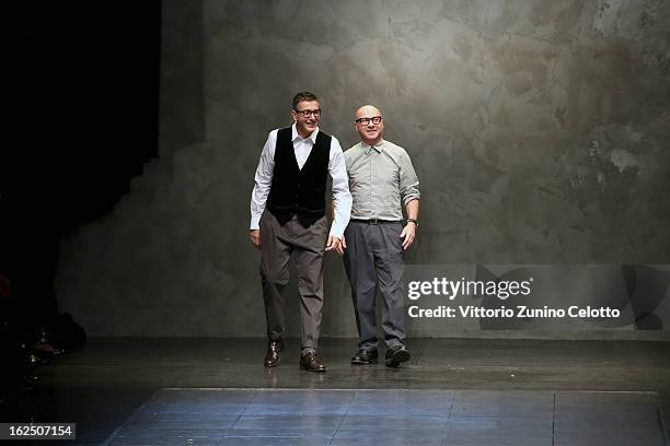 Stefano Gabbana and Domenico Dolce acknowledge the applause of the audience after the runway at the Dolce & Gabbana fashion show as part of Milan...