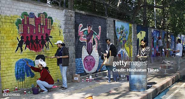 Delhi University students and NGO volunteers painting on the walls make "Graffiti" at North Campus Delhi University on February 24, 2012 in New...