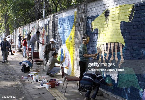 Delhi University students and NGO volunteers painting on the walls make "Graffiti" at North Campus Delhi University on February 24, 2012 in New...