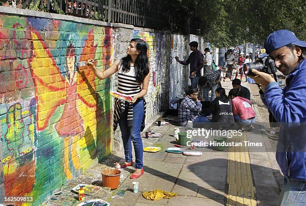 Delhi University students and NGO volunteers painting on the walls make "Graffiti" at North Campus Delhi University on February 24, 2012 in New...