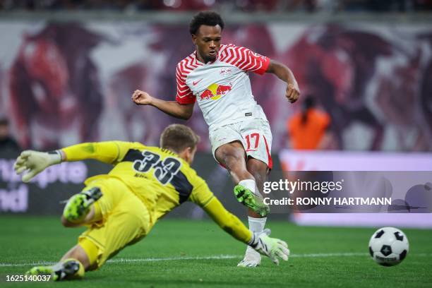 Leipzig's Belgian forward Lois Openda kicks the ball next to Stuttgart's German goalkeeper Alexander Nuebel during the German first division...