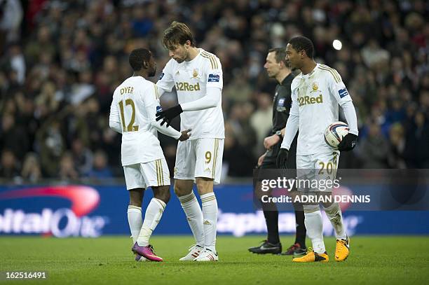 Swansea City's English midfielder Nathan Dyer is consoled by Swansea City's Spanish midfielder Miguel Michu after losing out on penalty-taking duties...