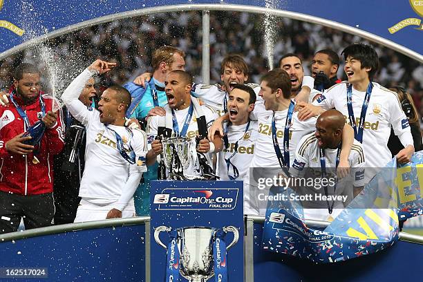 Captain Ashley Williams of Swansea City and team mates celebrate with the trophy during the Capital One Cup Final match between Bradford City and...