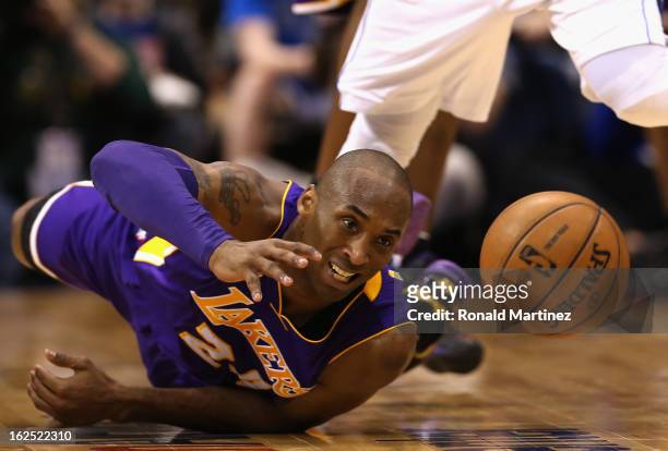 Kobe Bryant of the Los Angeles Lakers falls after fouled by O.J. Mayo of the Dallas Mavericks at American Airlines Center on February 24, 2013 in...