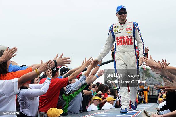 Dale Earnhardt Jr., driver of the National Guard Chevrolet, greets fans before the start of the NASCAR Sprint Cup Series Daytona 500 at Daytona...