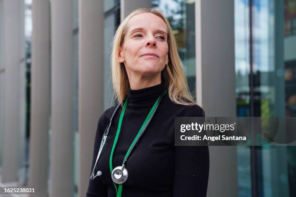 healthcare professional looking ahead with stethoscope - ahead stock pictures, royalty-free photos & images