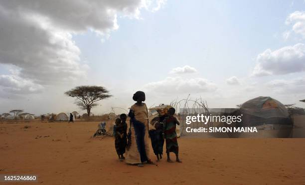 Newly arrived Somali refugees stand in front of their makeshift home at the Dadaab refugee camp on July 10,2011 in northeastern Kenya. Thousands of...