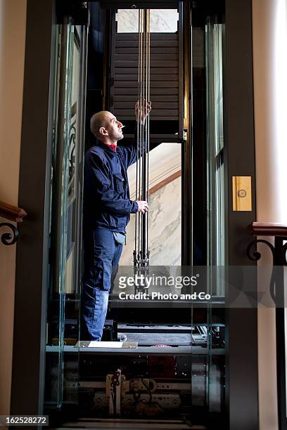 repairman maintenance and repair of a lift - elevator stock pictures, royalty-free photos & images