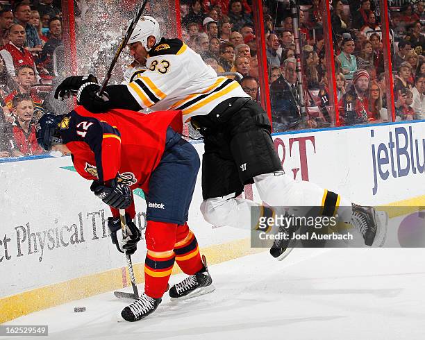 Zdeno Chara of the Boston Bruins checks Jack Skille of the Florida Panthers into the boards at the BB&T Center on February 24, 2013 in Sunrise,...