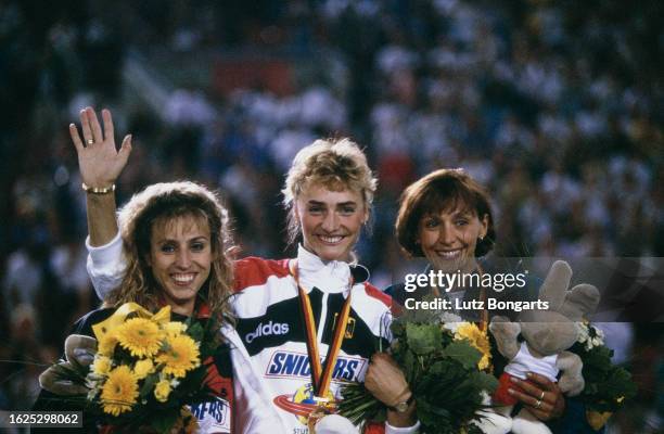 Danish athlete Renata Nielsen, German athlete Heike Drechsler, and Ukrainian athlete Larysa Berezhna on the winners' podium after the women's long...