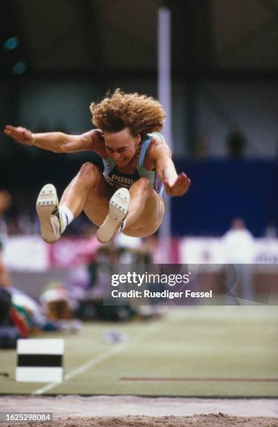 German athlete Heike Drechsler, wearing a dark blue-and-light blue leotard competes in the women's long jump event of the International Hallenmeeting...