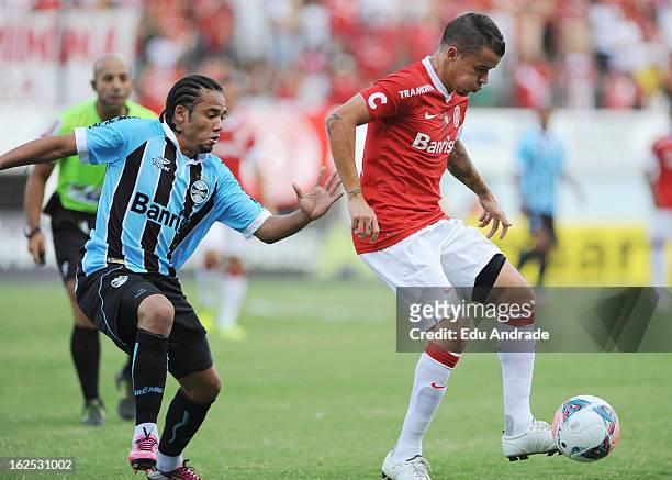Alessandro, of Internacional struggles for the ball with Adriano of Gremio during a match between Gremio and Internacional as part of the Gaucho...