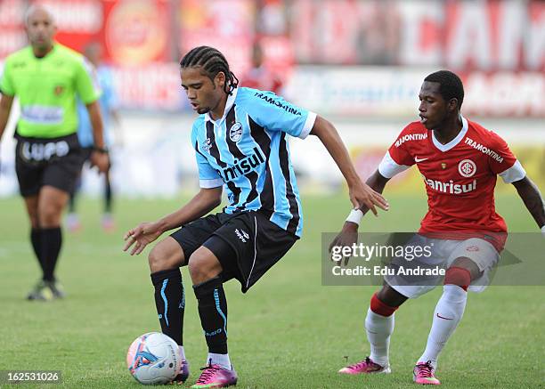 Fred, of Internacional struggles for the ball with Adriano of Gremio during a match between Gremio and Internacional as part of the Gaucho...