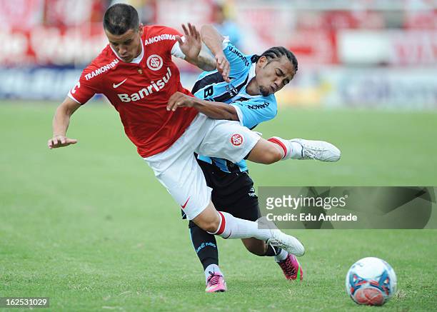 Alessandro, of Internacional struggles for the ball with Adriano of Gremio during a match between Gremio and Internacional as part of the Gaucho...