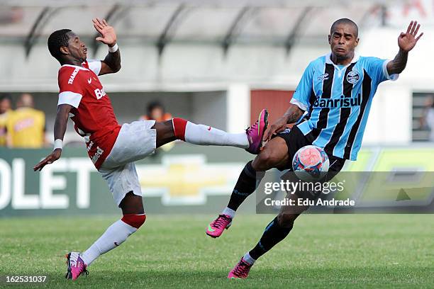 Fred, of Internacional struggles for the ball with Welliton of Gremio during a match between Gremio and Internacional as part of the Gaucho...