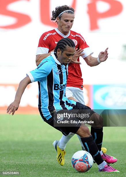 Adriano of Gremio fights for the ball with Diego Forlan of Internacional during a match between Gremio and Internacional as part of the Gaucho...