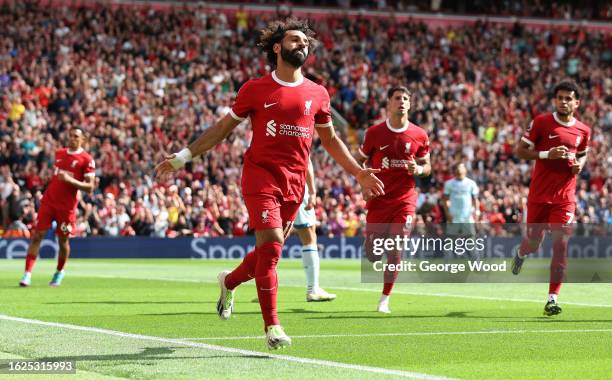 Mohamed Salah of Liverpool celebrates after scoring the team's second goal after scoring off the rebound of a missed penalty during the Premier...