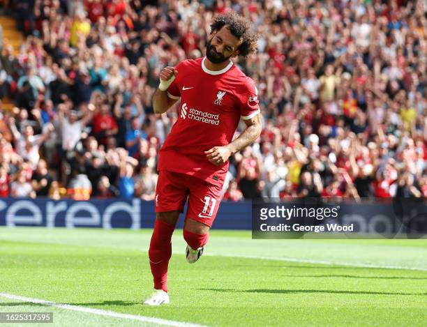 Mohamed Salah of Liverpool celebrates after scoring the team's second goal after scoring off the rebound of a missed penalty during the Premier...