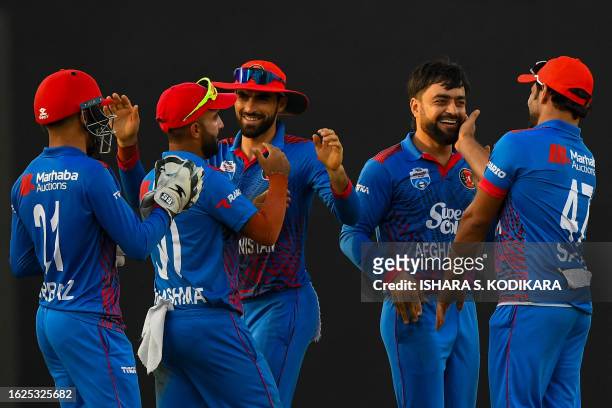 Afghanistan's Rashid Khan celebrates with teammates after the dismissal of Pakistan's Babar Azam during the third and final one-day international...