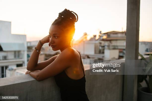 african woman posing on a rooftop - washington dc women stock pictures, royalty-free photos & images