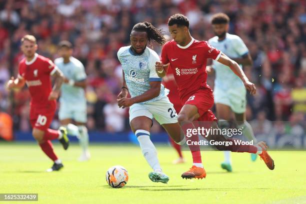 Cody Gakpo of Liverpool competes for the ball with Antoine Semenyo of AFC Bournemouth during the Premier League match between Liverpool FC and AFC...
