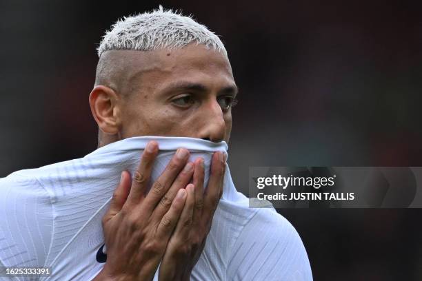 Tottenham Hotspur's Brazilian striker Richarlison wipes rain from his face during the English Premier League football match between Bournemouth and...