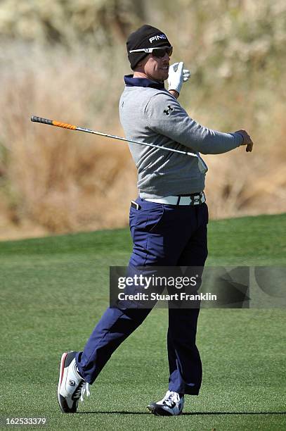 Hunter Mahan drops his club as after he hit a shot from the fairway on the eighth hole during the final round of the World Golf Championships -...