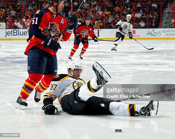 Brian Campbell of the Florida Panthers tangles with Patrice Bergeron of the Boston Bruins at the BB&T Center on February 24, 2013 in Sunrise, Florida.